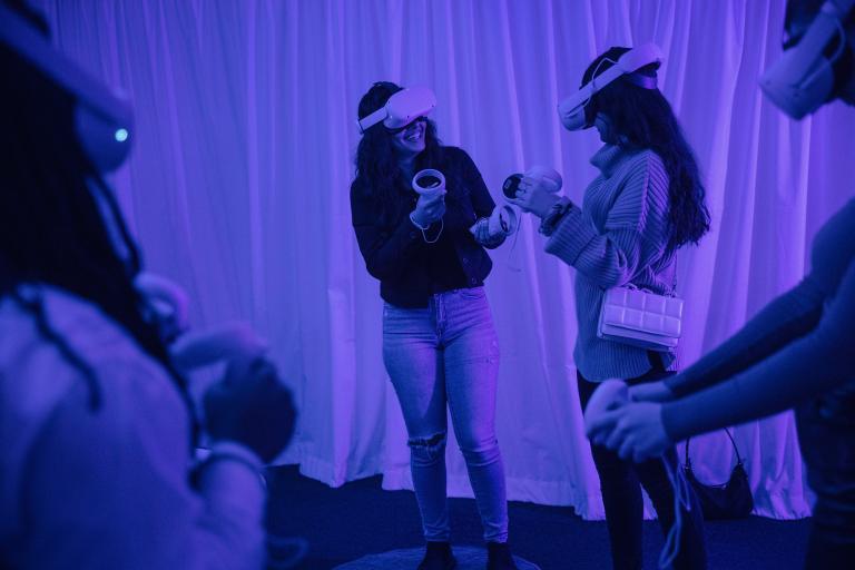 Ungdomar med VR-headset som skrattar och hjälper varandra i VR