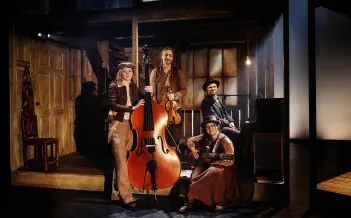 Fyra musiker står med sina instrument: kontrabas, fiol, piano och gitarr.